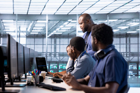 Team of data center office system administrators using programming languages to construct algorithms...
