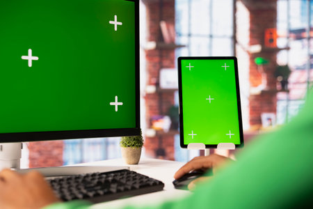 Person using green screen PC in home office to write emails. Remote employee typing on mockup computer keyboard, composing documents in order to deliver finalized project paperworkの写真素材