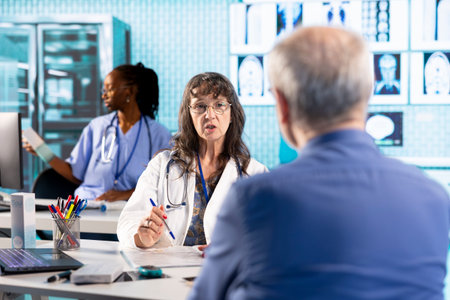 Senior woman physician and patient engage in a medical examination with diagnostic tools to provide...