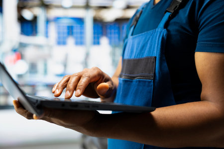 Male engineer works on solar energy software settings in high tech factory, optimizing the...