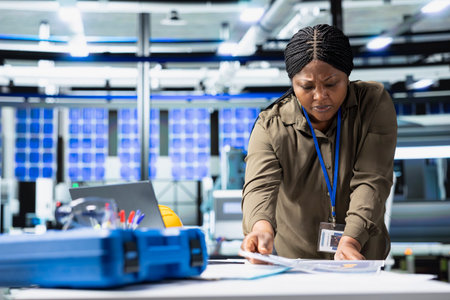 Female master engineer performing quality control on solar power production, showcasing cheaper...