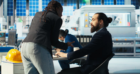Man in photovoltaics factory talking with woman, diagnosing malfunctioning systems. Solar panels...