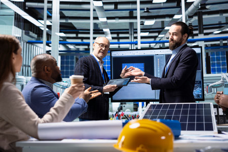 Investors meeting with factory management to evaluate regulatory manufacturing safety issues, before agreeing deal. Shareholders analyzing potential risk areas before investing in industrial plantの写真素材