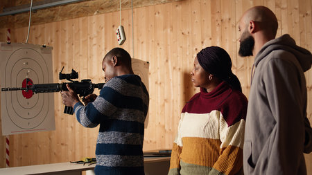 Shooting range safety officer demonstrating how to safely reload semiautomatic weapon to customers,...