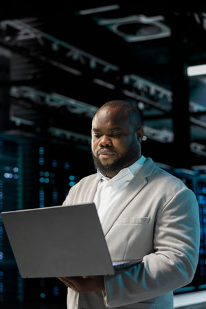 Server hub developer using laptop to fix network issues affecting storage arrays, doing backups....