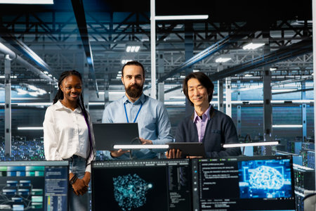 Portrait of smiling multiethnic engineers in data center troubleshooting server connectivity issues using AI. Upbeat multiracial technicians in diverse server room auditing systems for vulnerabilitiesの写真素材