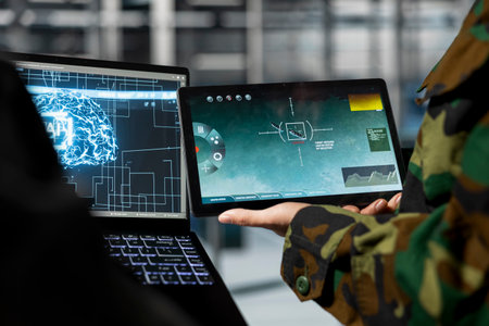 Close up of military server room engineers analyzing neural networks powered surveillance data together. Data center army specialists comparing AI generated target coordinatesの写真素材