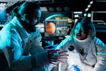 Astronauts on orbital station doing brainstorming while flying to Mars, deciding trajectory. Cosmonauts talking in spaceship about red planet surface research journey travelling pathの写真素材