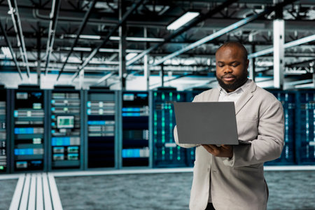 Data center software developer running error checking utilities on laptop, automating anomaly...