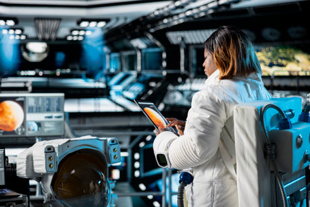 Female astronaut in orbital station analyzing Mars planetary data on tablet. Crew member in...