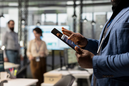 Close up of african american expert uses digital tools for KPI analytics to build a new vision,...