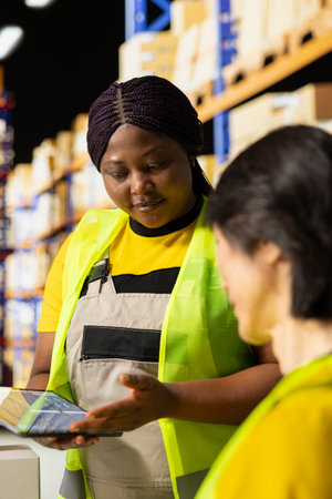 Diverse employees handle tracking operations with awb numbers on packages, monitoring parcel status...