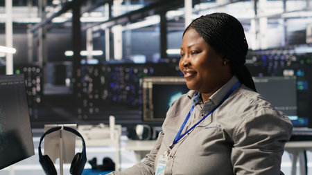 Data center programmer coding on PC, doing software updates for AI visualization systems. African...