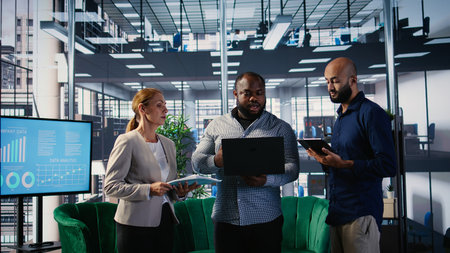 Multiethnic group of business partners discussing about a new growth strategy, goal oriented specialists ensuring global development and a success story. Networking. Camera A.の写真素材