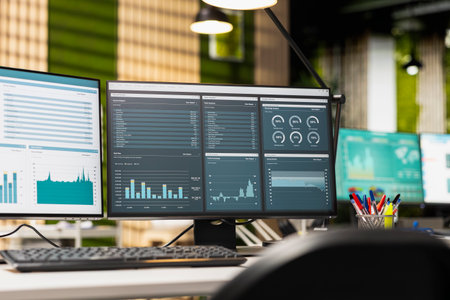 Empty business office is equipped with resources and dual monitors, digital tools for forecasting,...