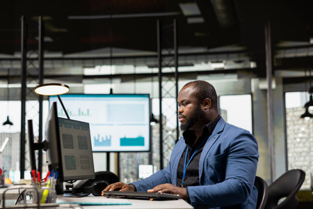 Black office consultant reviewing performance metrics and monthly reports, preparing business vision for greatness within the corporate environment. Management strategy for innovation.の写真素材