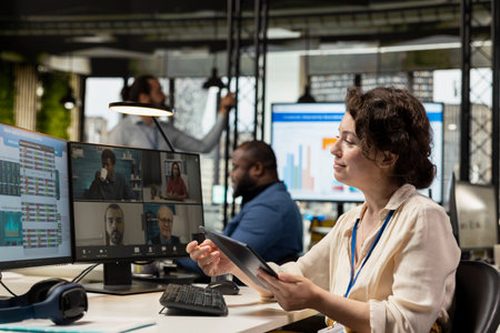 Employees sharing ideas on a web video conference call at the workstation, discussing about project...