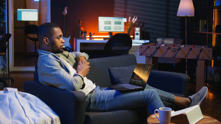 Freelancer joining a teleconference call for remote workshop lesson, maintaining a strong digital connection for effective online course. Man engaging in discussion via virtual chat. Camera A.の写真素材