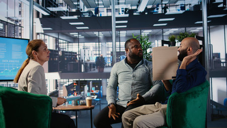 Office life showing frustration and dispute during a business discussion, with leaders facing disagreement and workplace tension in a multicultural goal oriented company.の写真素材