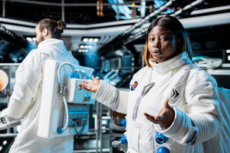 Astronaut doing video briefing with Earth based scientists team while orbiting in space station. Starship crew member presents current mission status during remote videocallの写真素材