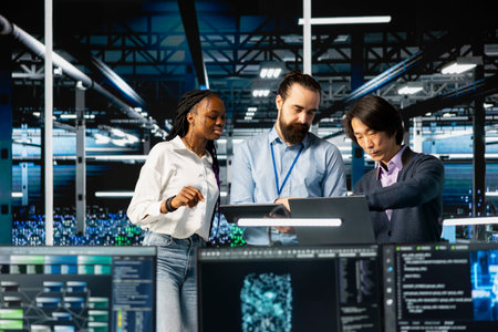 Team of engineers in data center monitoring AI applications, adjusting machine learning. Server hub...