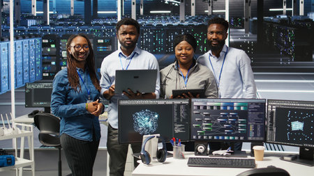 Portrait of smiling data center technicians analyzing infrastructure issues using node tree tools....