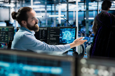 Team leader guiding intern in server room to review infrastructure diagnostics. IT specialist and...