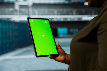 Data center technician using isolated screen tablet to automate anomaly detection. Server farm employee using chroma key device, minimizing downtime through predictive maintenanceの写真素材