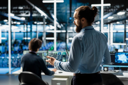 Teamworking admins coding in data center, updating AI driven automation scripts. Server room...