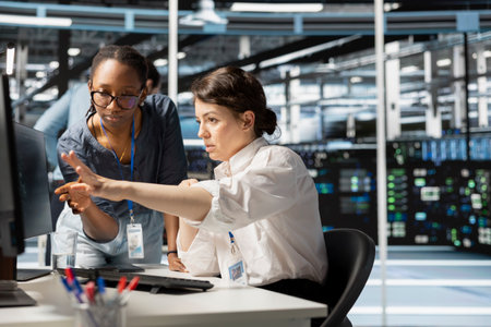 Data center manager supervising engineer implementing technology to improve resource allocation....