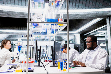Laboratory bioinformatics scientist evaluates genetic markers associated with disease risk using PC...