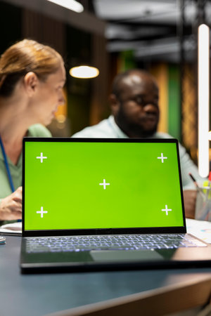 Corporate team participate in late night advisory board session with mockup, planning strategy, setting goals for project agenda. Experts reviewing updates with partners across the enterprise.の写真素材