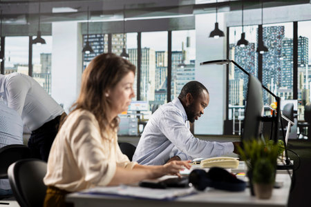 Professional staff analyzing finance numbers and corporate documents during business meeting. Team...