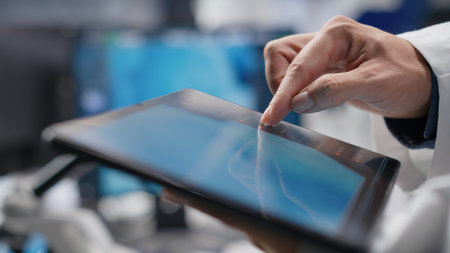 Close up of tablet with modern laboratory software used by scientist for a science experiment, advanced tech. Focused on molecular biology, biotechnology and healthcare innovation.の写真素材