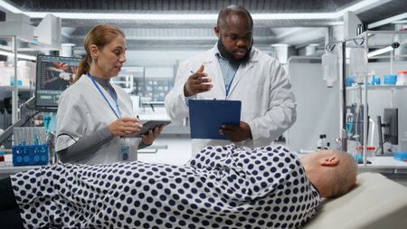 Diverse healthcare workers examine a patient during a drug trial, monitoring treatment outcomes,...