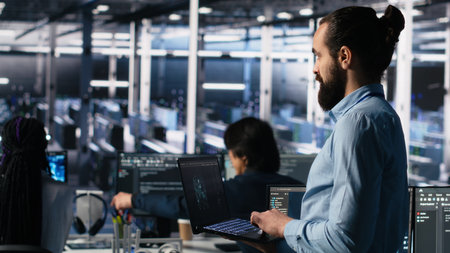 Server room technician using AI LLM chatbot to review infrastructure diagnostics. IT expert in data center using artificial intelligence large language model to analyze performance data, camera Aの写真素材