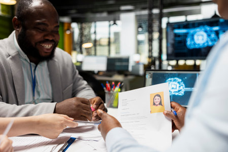 Diverse recruiters using deep learning pc software for profile evaluation, filtering through applicants CV data and helping HR team with decision making. Filling in the company job opening.の写真素材