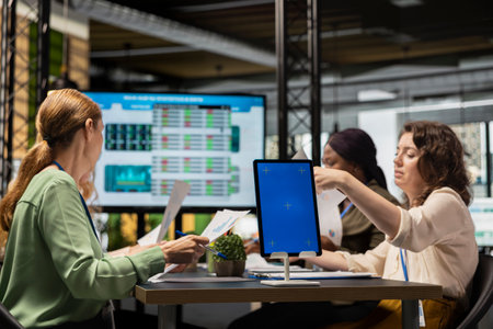 Business associates attending a meeting in the office with a mockup screen, briefing session for brainstorming development ideas and building a new strategy. Objectives planning.の写真素材