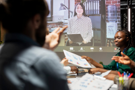 Multinational company staff in a briefing with CEO via video call, global business meeting held to collaborate on development insights, review feedback and setting clear objectives for success.の写真素材