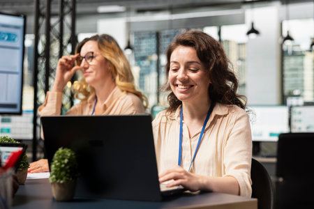Ambitious focused businesswoman at desk reviewing business strategy after collecting reports data and performance indicators, aligning development goals driven by success. Report writing.の写真素材