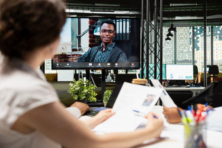 HR employees and candidate meeting online via video call connection to discuss onboarding, review...