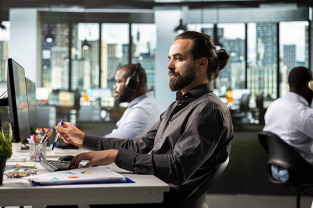 Corporate employee works at computer to solve finance tasks, meeting objectives and coming up with...
