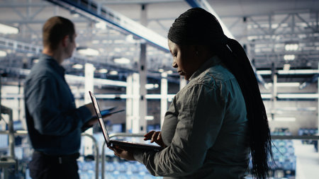 Data center admin investigates AI configurations using laptop, making adjustments to ensure optimal...