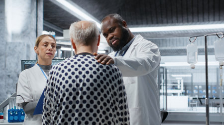 Doctor and nurse in a clinical trial institute examining a patient, studying the effects of a new drug through testing and monitoring vitals. Ensuring dosage safety in pharmacology. Camera B.の写真素材