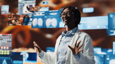 Smiling healthcare researcher mesmerized by futuristic medical data visualizations, working on disease prevention research. Scientist awed by high tech patient scans on digital interface, camera Bの写真素材