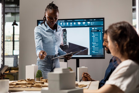 African american real estate engineer presenting site preparation plan and zoning regulations on 3D...