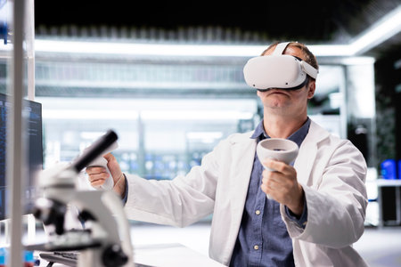 Researcher in lab workspace uses VR headset to explore three dimensional models of cellular biology. The simulation highlights innovation in biotechnology research and molecular science.の写真素材