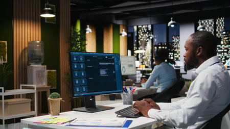 Black worker uses AI chatbot system at desktop for problem solving tasks, futuristic technology...