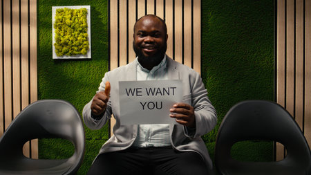 Black business person from the hiring team displaying advertisement banner promoting open positions,...