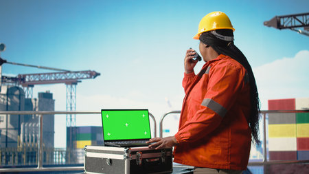 Isolated screen laptop used by energy production company worker to determine optimal drilling rig...